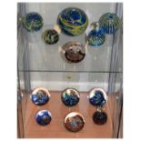 Collection of twelve modern glass paperweights comprising: six by Mdina and six by Selkirk