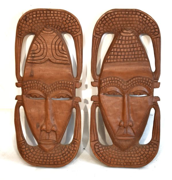 Pair of African carved wooden wall masks of shield design Condition: