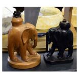 Two African carved wooden lamp bases, each modelled as a standing elephant Condition: