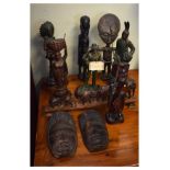Group of African and other ornaments to include a standing figure with enlarged ovoid head, long