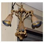 Art Nouveau style brass and mottled glass ceiling light having three bellflower type shades on
