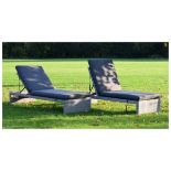 Two modern wicker effect sun loungers, each with reclining back and padded removable cushions