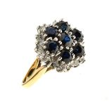 Sapphire and diamond cluster ring, stamped '18ct', the central seven sapphires enclosed by twenty-