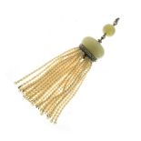 Jade, diamond and seed pearl tassel pendant, circa 1920, the jade bead with a diamond suspension