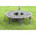 Cast iron circular tree seat made in four sections, the top decorated with pierced palmettes, the