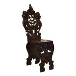 19th Century Italian carved walnut 'Scabello' chair, the intricately-carved back with mask of