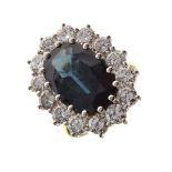 Sapphire and diamond cluster ring, in 18ct gold, the sapphire approximately 14.2mm x 9.6mm x 5mm