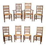 Eight rush seated spindle back ash and fruitwood dining chairs, to include; two elbow chairs, each