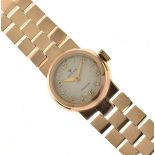 Rolex - Lady's 9ct gold bracelet watch, the circular white textured dial with gilt hands, Arabic