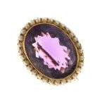 Victorian amethyst and split pearl oval brooch, stamped '15ct', 2.6cm x 2.1cm, 7.6g gross Condition: