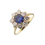 Sapphire and diamond cluster ring, unmarked, the oval sapphire measuring approximately 6.4mm x 5mm x