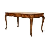 Continental figured walnut library or centre table, early 20th Century of wavy outline fitted two