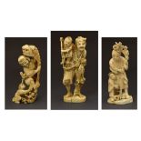 Three Japanese carved ivory okimono, each depicting a man and a boy, Meiji period, 9.75cm, 11cm