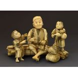 Japanese carved ivory okimono depicting a seated farmer with two boys, the underside with