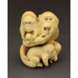 Small Japanese carved ivory okimono depicting a monkey with two young, signed, Meiji period, 4cm