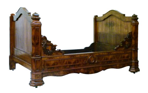 19th Century Continental walnut and figured walnut bedstead having carved decoration, overall