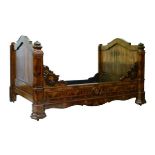 19th Century Continental walnut and figured walnut bedstead having carved decoration, overall