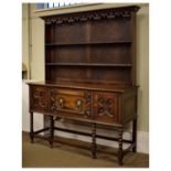 Early 20th Century oak high dresser in the late 17th Century taste, the rack with beaded cornice and