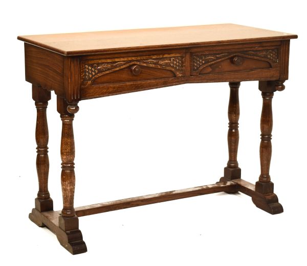Vintage carved oak two drawer side table with rectangular top over leaf and berry carved drawers