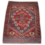 Early 20th Century Caucasian rug having typical geometric decoration on a blue and red ground within