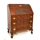 Early 20th Century carved mahogany bureau with stipple-carved foliate scroll work slope and