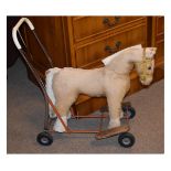 Vintage child's ride-on toy horse with horsehair filling, leather bridle and bit on red painted