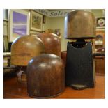 Vintage treen and iron crank-operated hat stretcher together with three wooden hat/wig stands of