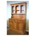 20th Century yellow pine two stage cabinet or dresser, the upper section having two glazed doors