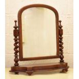 Victorian mahogany swing dressing mirror with arched plain plate, on serpentine base Condition: