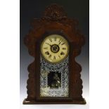 Late 19th Century American mantel clock with white Roman dial and glazed door within carved shaped