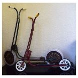 Two vintage Tri-ang scooters, the larger green painted with iron spoke wheels (2) Condition: