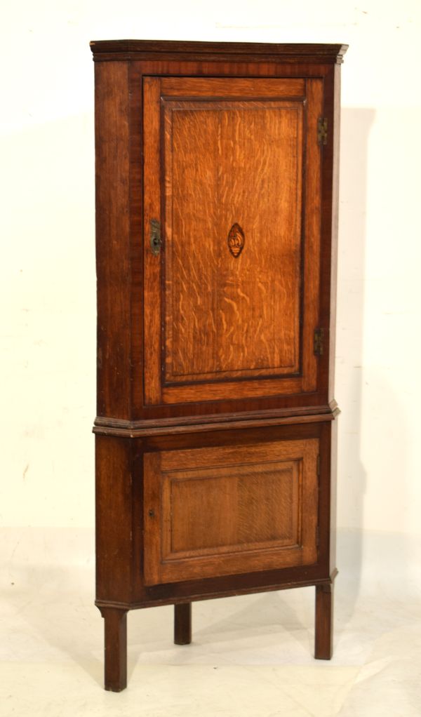 George III inlaid oak and mahogany corner cupboard, the fielded panelled door with shell patera