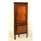 George III inlaid oak and mahogany corner cupboard, the fielded panelled door with shell patera