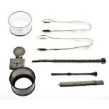 Small quantity of silver and white metal items including sugar tongs, napkin rings, stamp case, pens