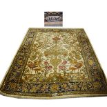 Wool carpet having tree of life decoration against a blue border, 170cm x 130cm Condition: