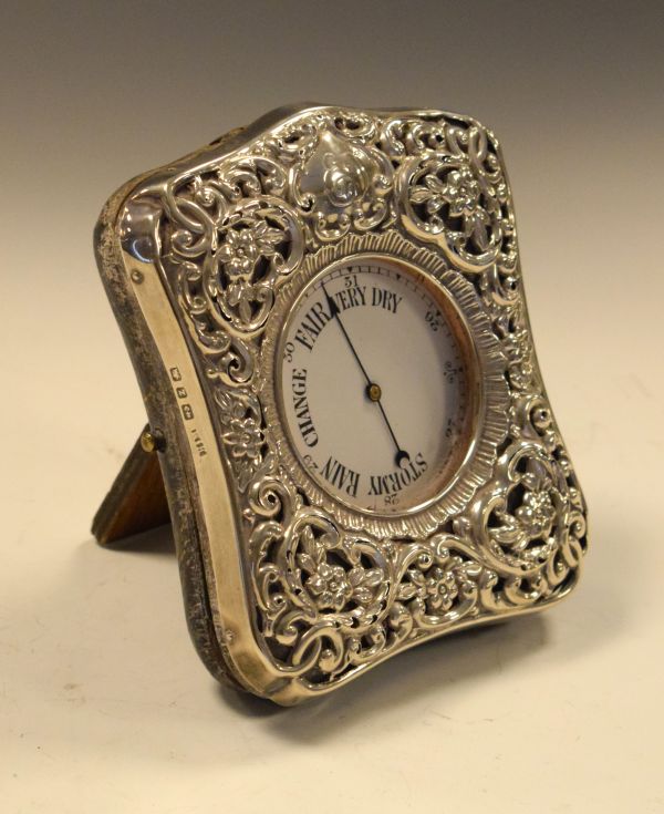 Victorian embossed and pierced silver mounted easel watch case having allover foliate decoration,