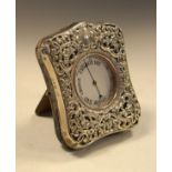 Victorian embossed and pierced silver mounted easel watch case having allover foliate decoration,