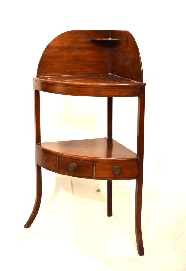 George III mahogany bowfront corner washstand having a shaped splashback with shelf over two