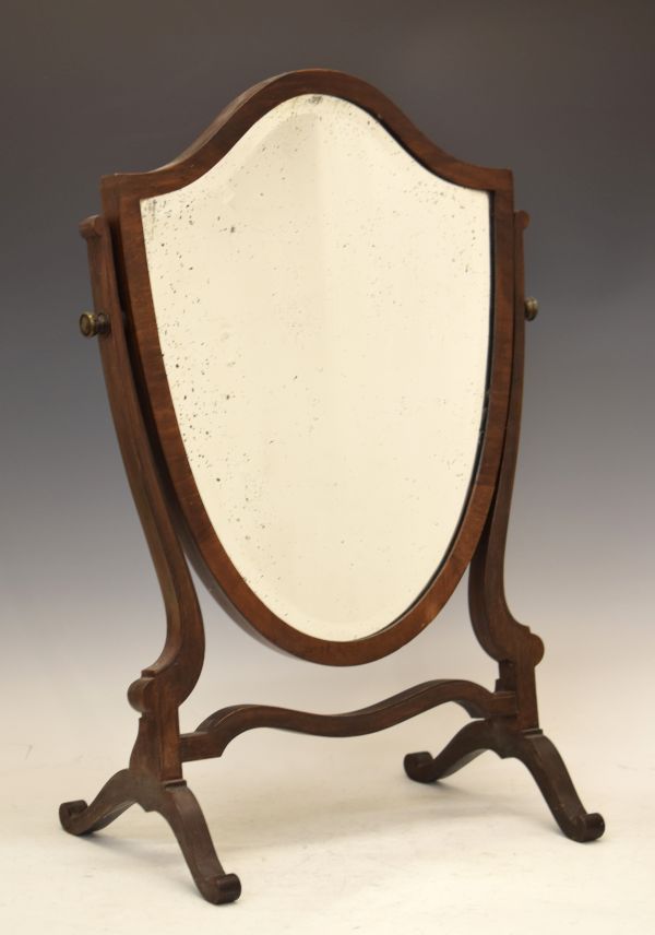 Early 20th Century mahogany swing dressing mirror having a bevelled shield shaped plate Condition: