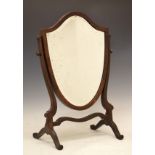 Early 20th Century mahogany swing dressing mirror having a bevelled shield shaped plate Condition: