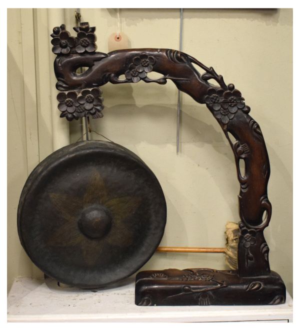 20th Century Far Eastern table gong, the brass gong on a carved hardwood stand modelled as a