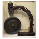 20th Century Far Eastern table gong, the brass gong on a carved hardwood stand modelled as a