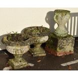 Pair of reconstituted stone garden urns of campana type, together with a third of two handled urn