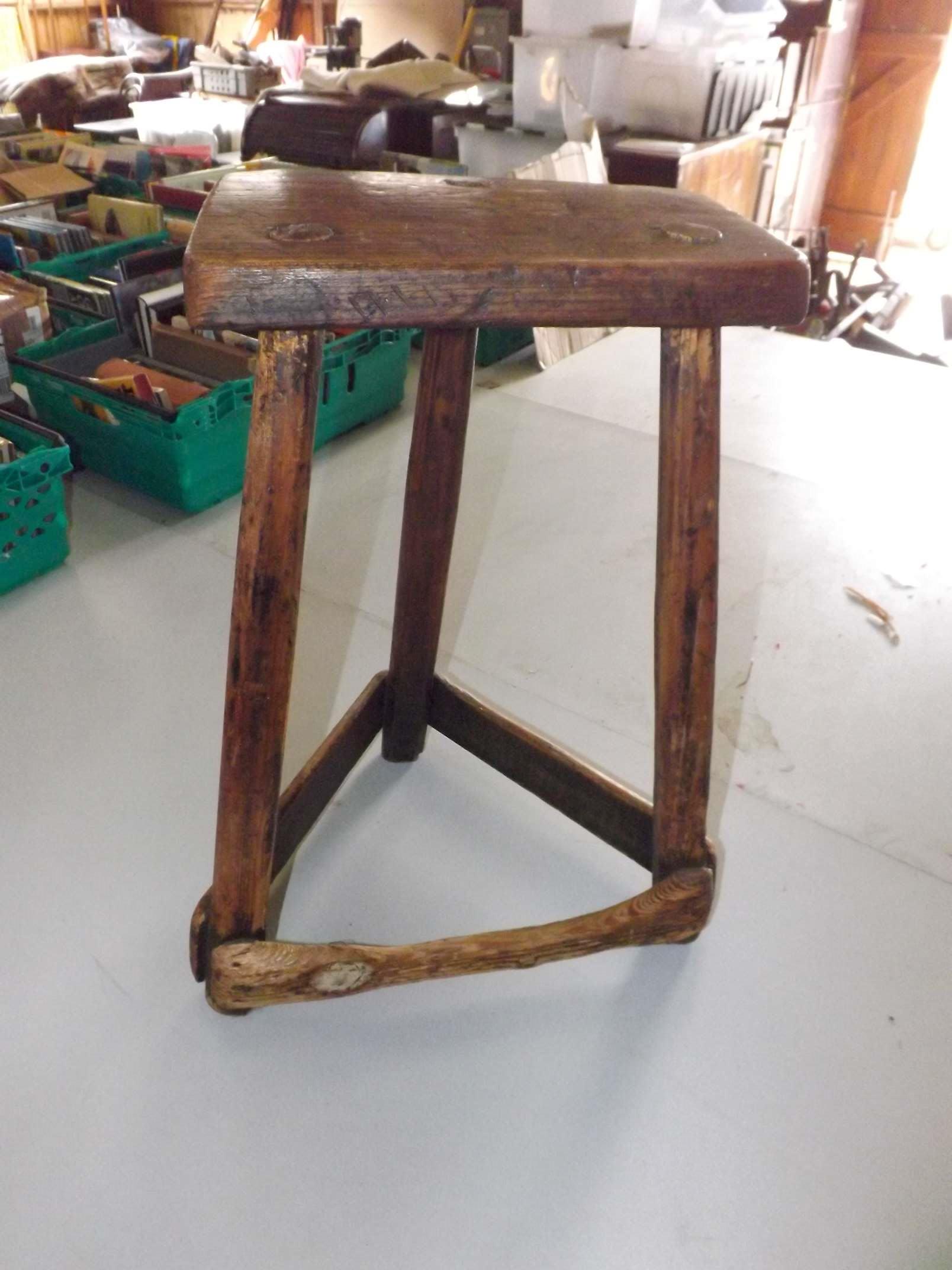 An antique country made 3-legged stool w