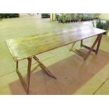 An antique plank top trestle table with