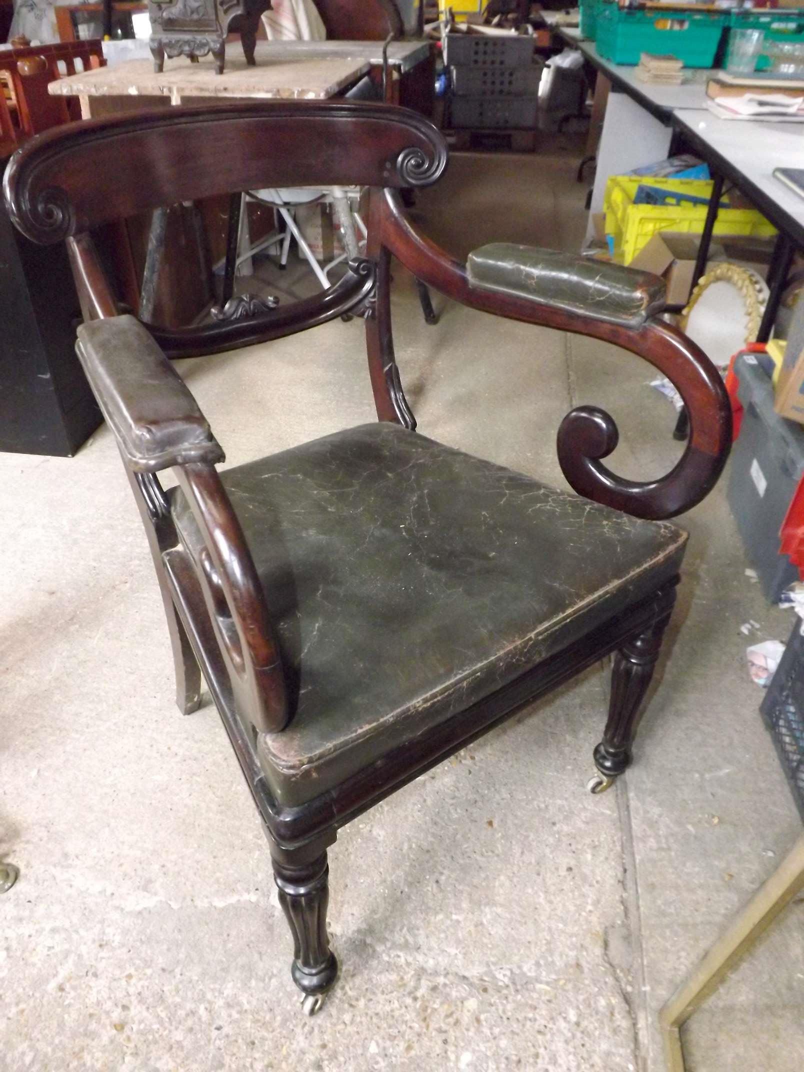 An antique arm chair with original leath