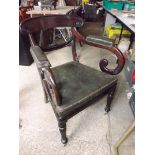 An antique arm chair with original leath
