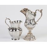 Two Buccellati Sterling Silver Pitchers. L: Ht. 8", W 7 1/2", 17 ozt. R: Ht. 11 1/2" W 8 1/2", 26