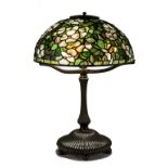 Fine and Rare Tiffany Studios New York Dogwood Leaded Glass and Bronze Table Lamp. The shade, with