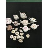 A collection of reproduction teapots (9) in fine porcelain, produced for the Victoria and Albert